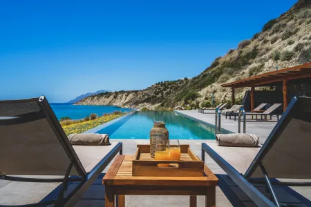  Sun loungers arranged beside swimming pool